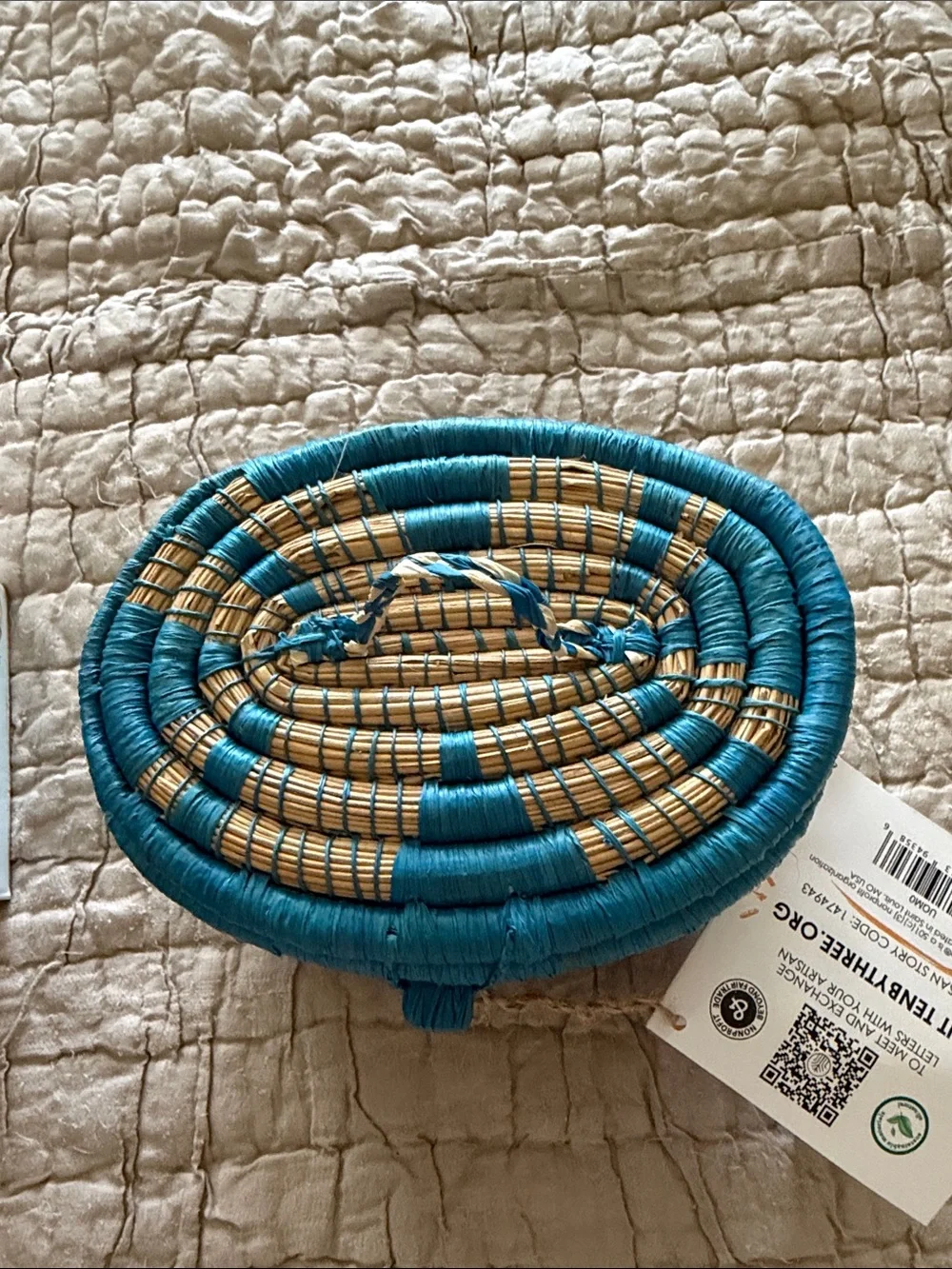 Handmade turquoise and tan coveted basket from Uganda clasp in the front